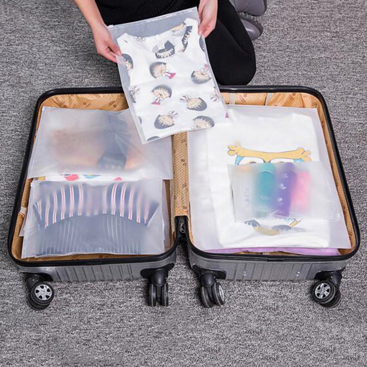 frosted, see-through storage bags from the set packed into an open suitcase